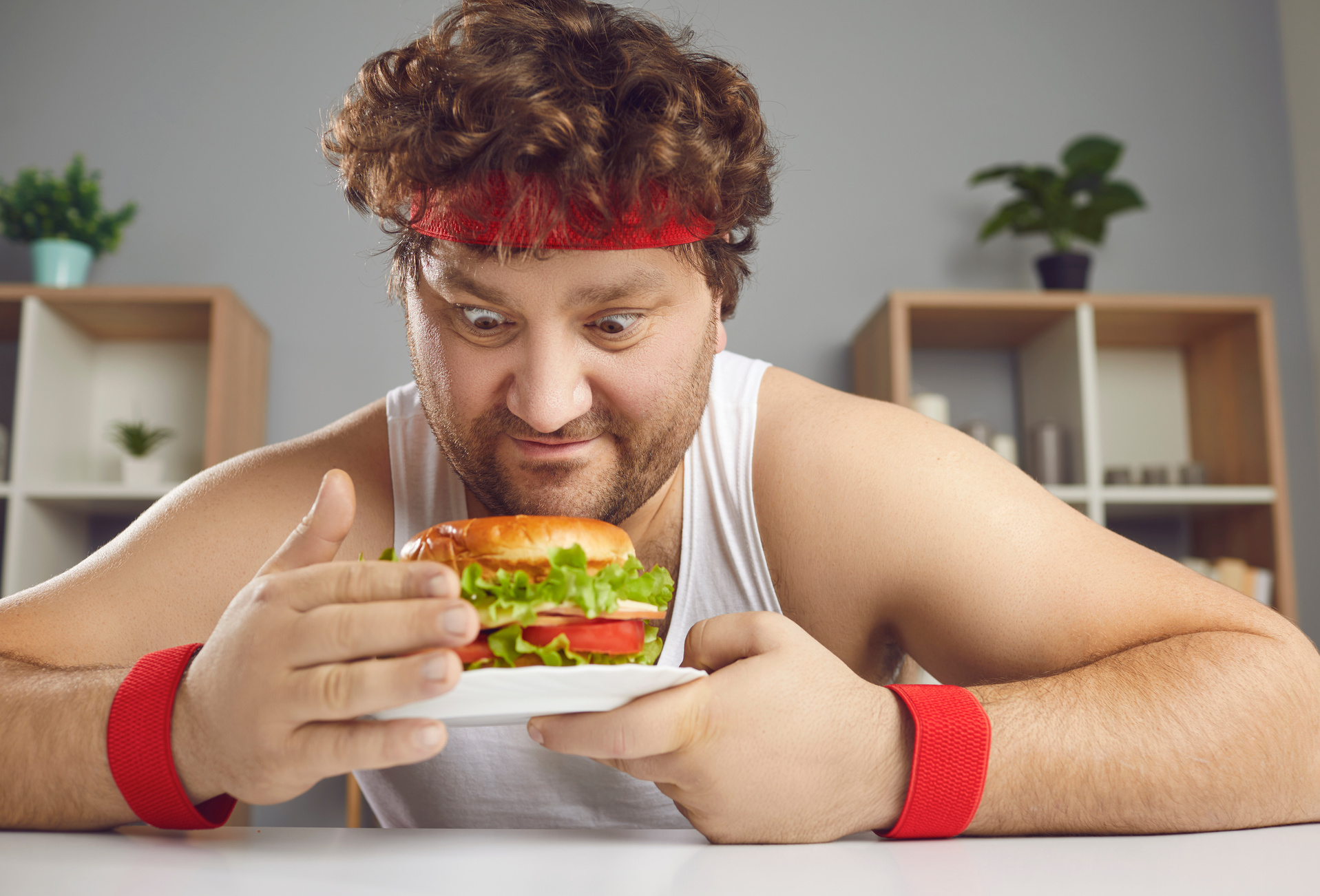 Funny Chubby Guy in Sportswear Is Being Tempted by Unhealthy but Delicious Burger